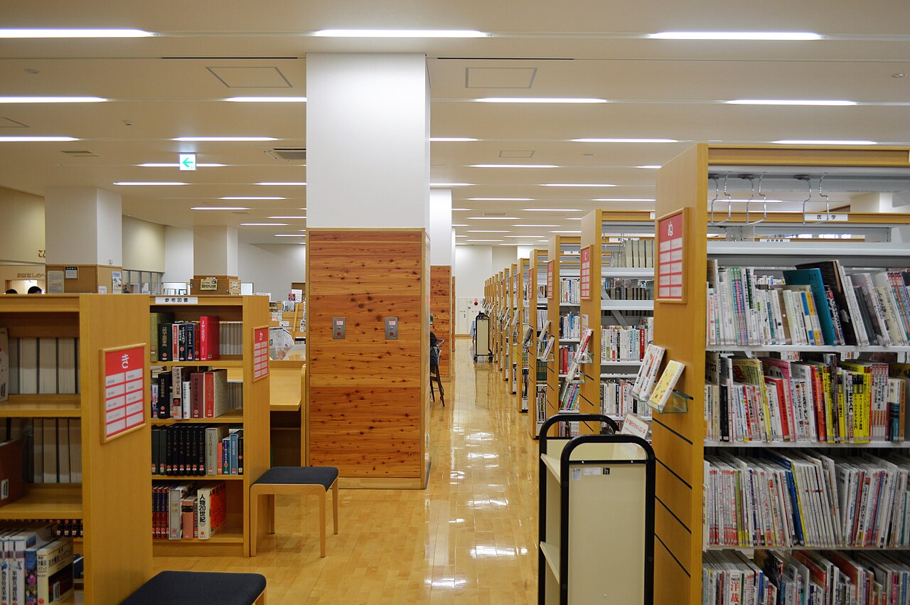 Pasillo con estanter&iacute;as de libros en una biblioteca p&uacute;blica
